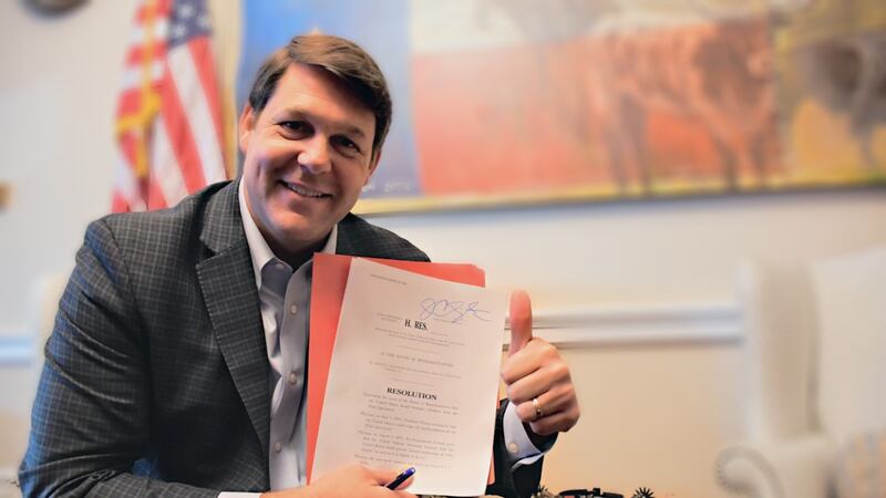 Congressman Jodey Arrington poses with a bill he introduced to the House of Representatives...
