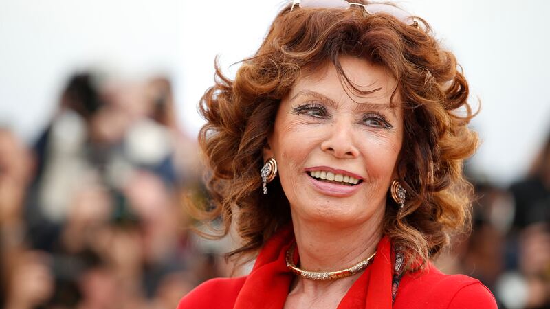 FILE - Italian actress Sophia Loren smiles during a photo call for "Human Voice," (Voce Umana)...