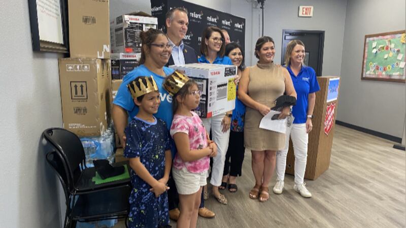 Family recieving AC unit from The Salvation Army and Reliant